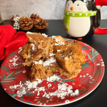slow cooker ginger bread French toast on a festive plate with holiday decor all around