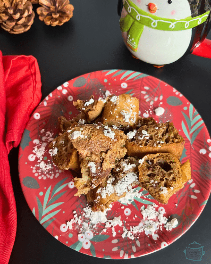 slow cooker ginger bread French toast on a festive plate with holiday decor all around