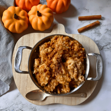 slow cooker pumpkin cobbler in a round pot with handles