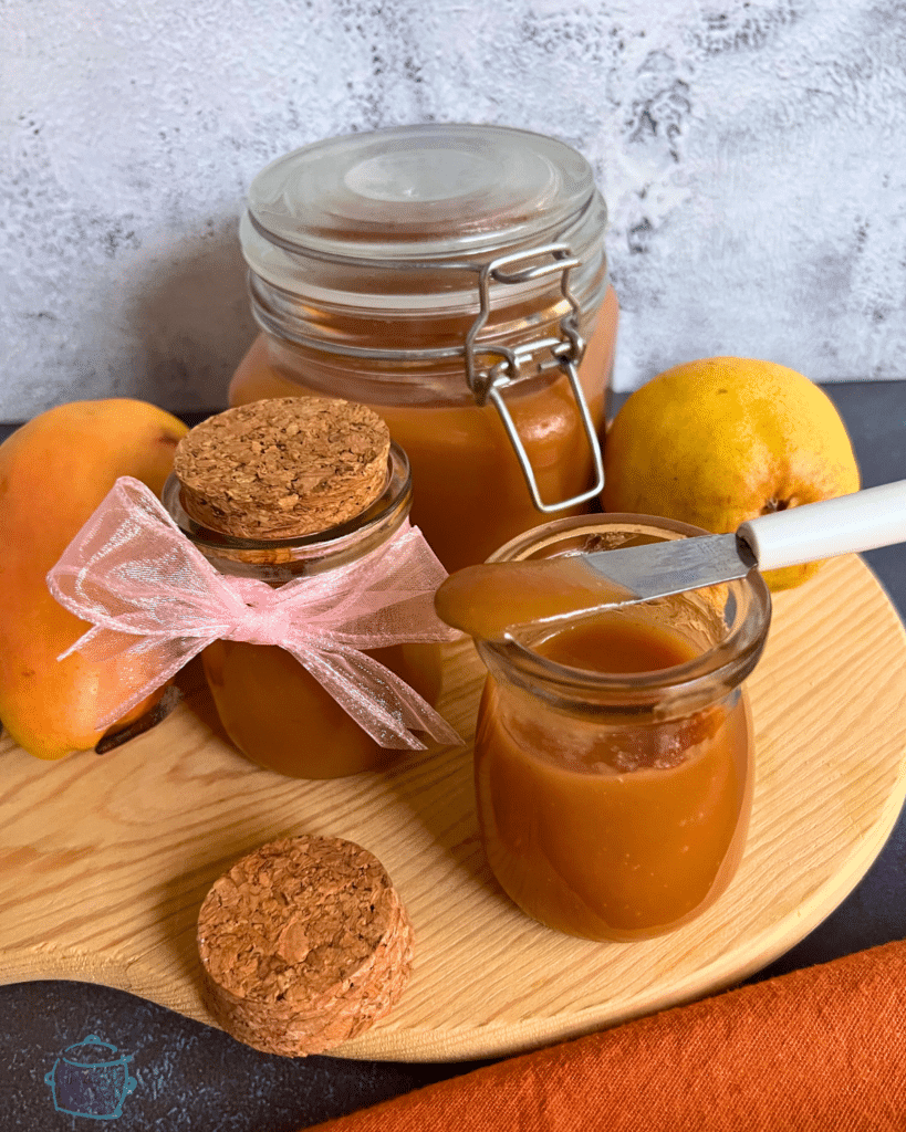 decorative jars filled with salted caramel pear butter on a cutting board