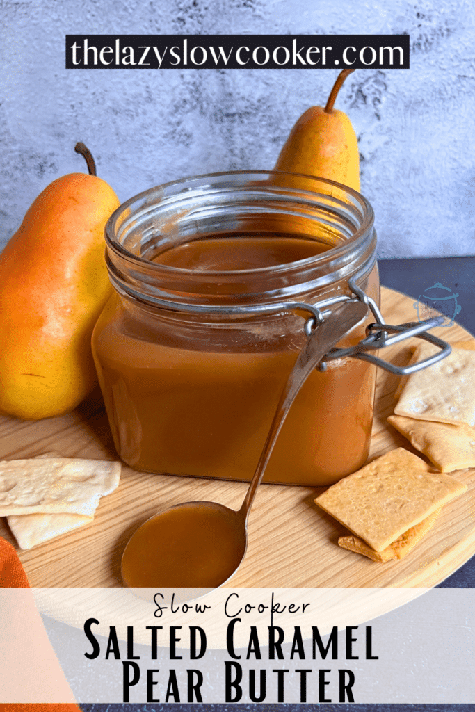 Slow cooker salted caramel pear butter in a jar with the lid off. A spoonful of the same is resting on the front of the jar.