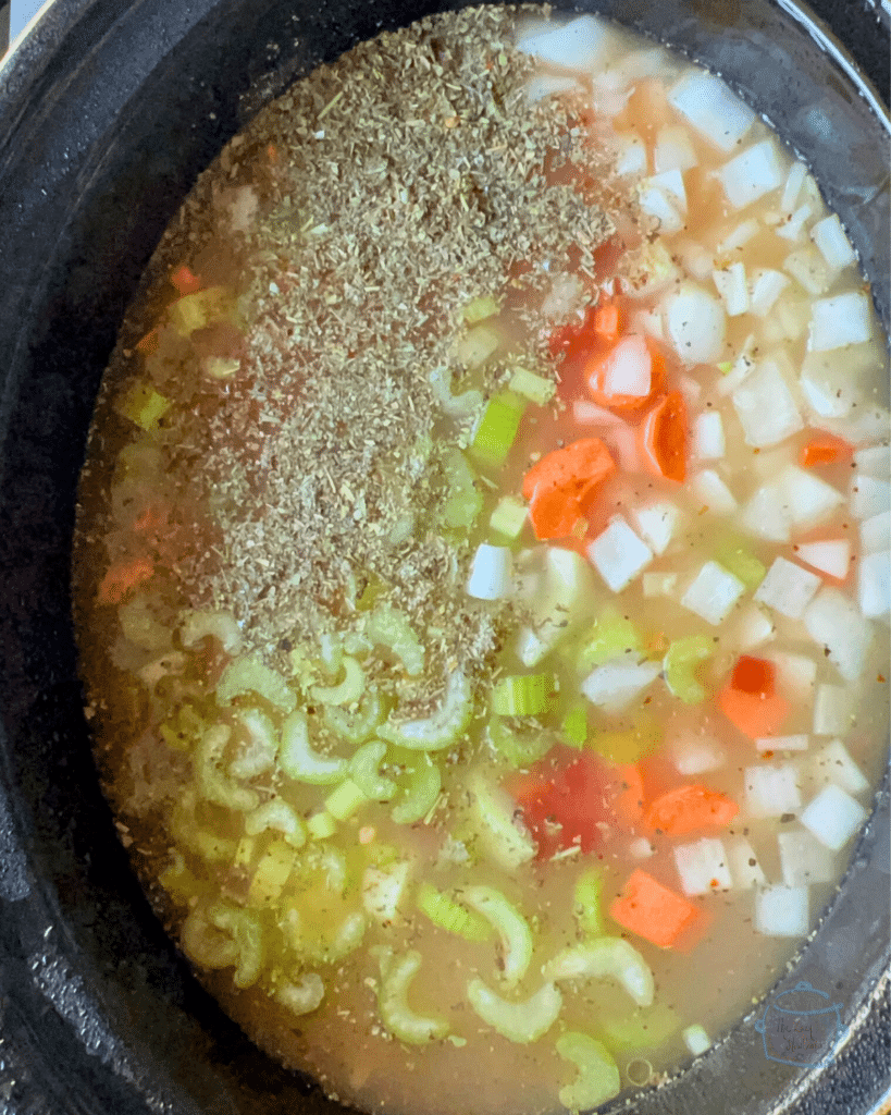 All slow cooker Italian chicken soup ingredients other than spinach and tortellini in a crockpot