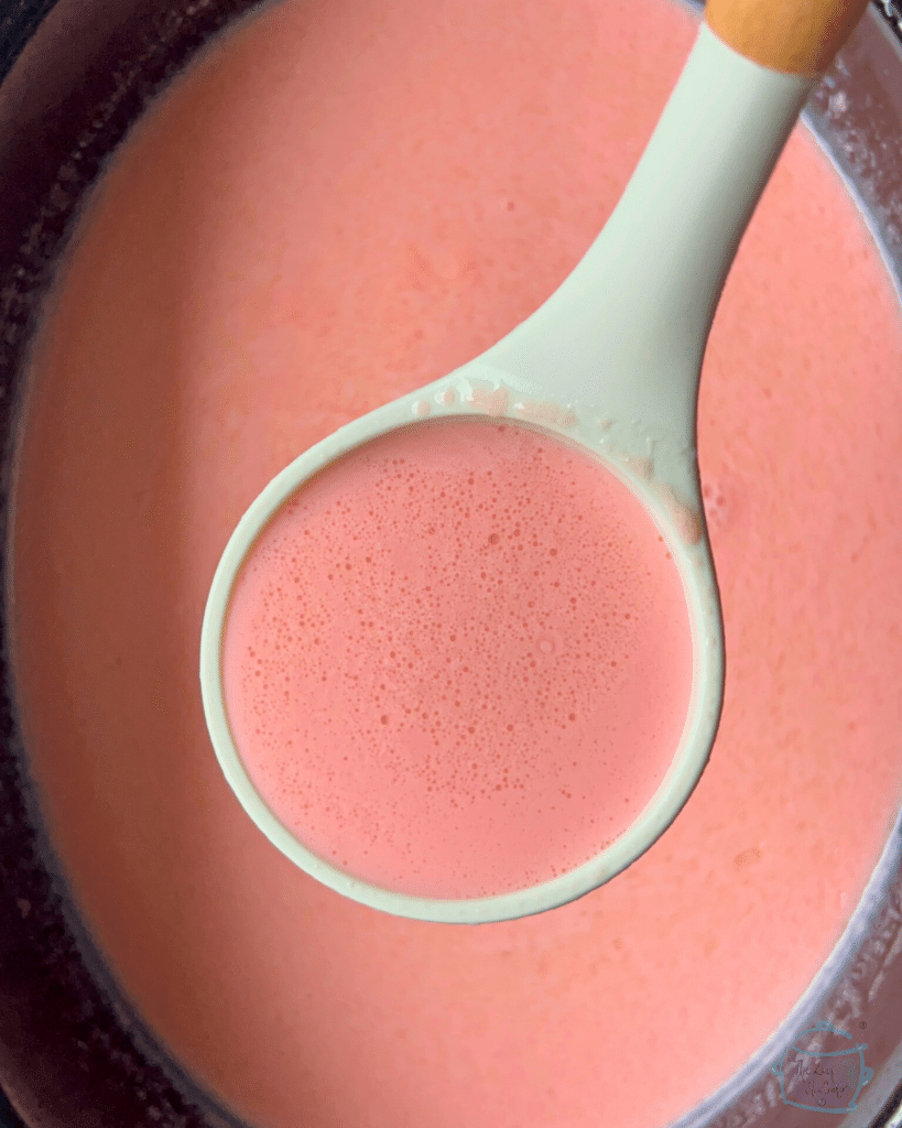 strawberry white hot chocolate on a ladle ready to serve
