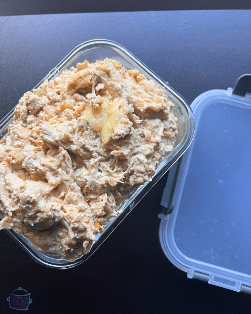 smothered onion dip chicken in an airtight container ready for storage