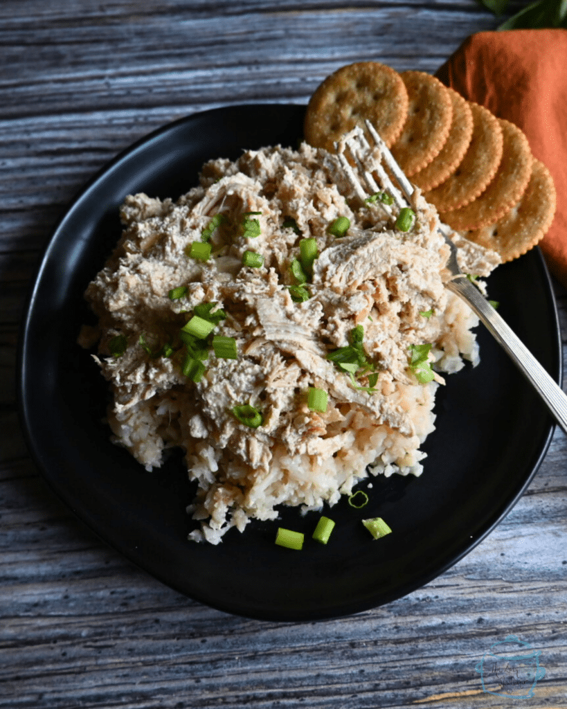 creamy french onion dip chicken on a bed of riced cauliflower on a black plate