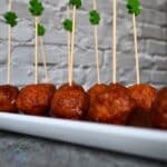 Guiness meatballs on a serving plate with shamrock picks