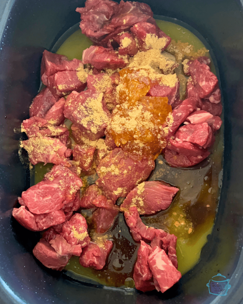 raw stew meat and all seasoning in slow cooker