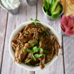shredded slow cooker beef shawarma in a round white bowl