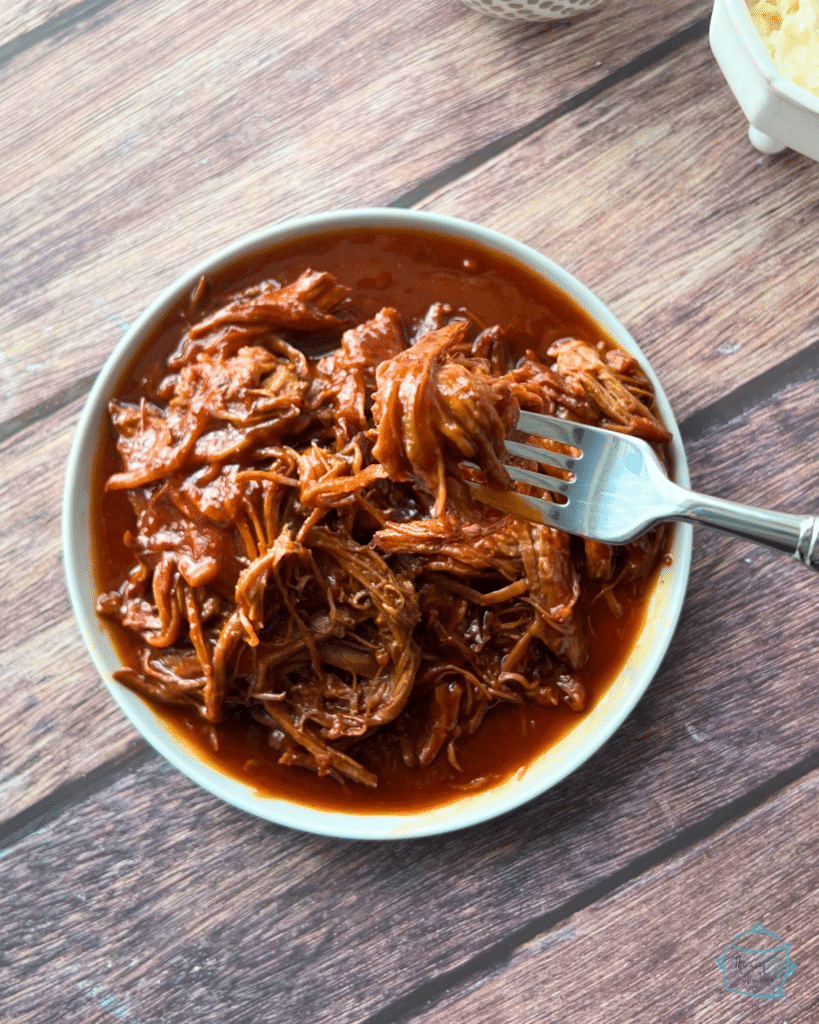 shredded brisket on a white round plate