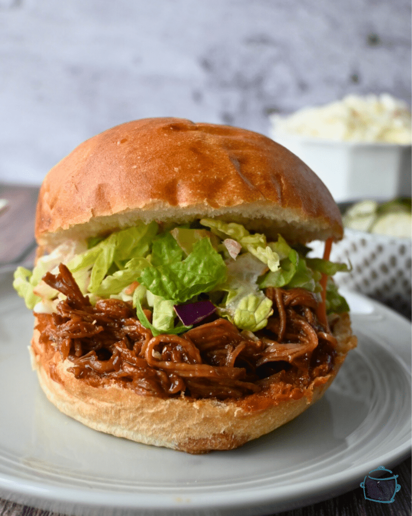 bbq brisket sandwich on a brioche bun with lettuce