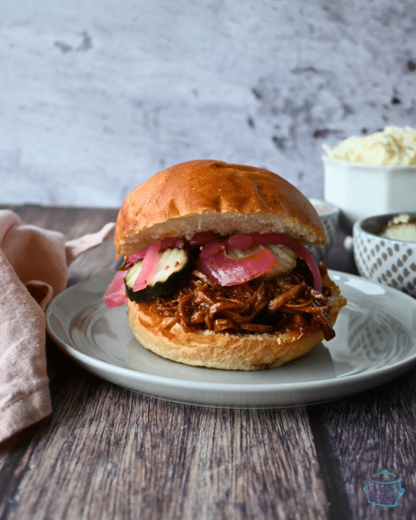 a juicy bbq brisket sandwich with pickles and pickled onion