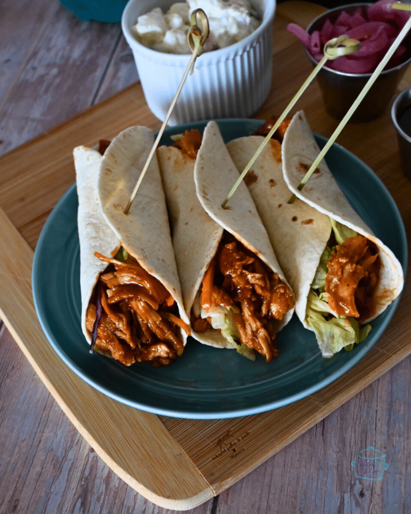 three wraps filled with bbq'd slow cooker turkey tenderloin.