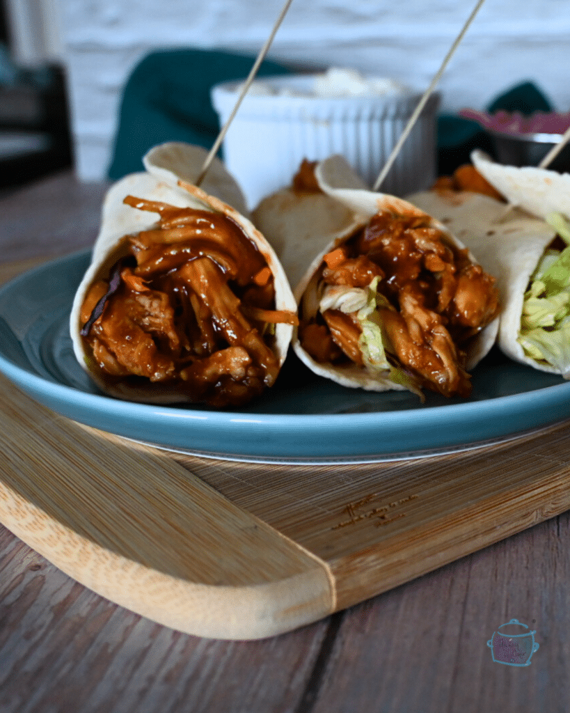 three wraps filled with bbq'd slow cooker turkey tenderloin.