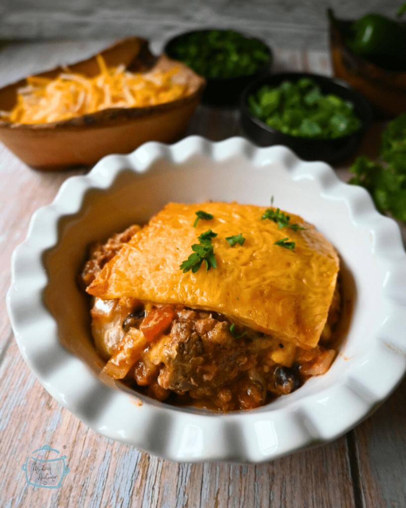 crockpot taco lasagna in a white bowl