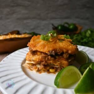 a slice of tortilla lasagna on a round white plate