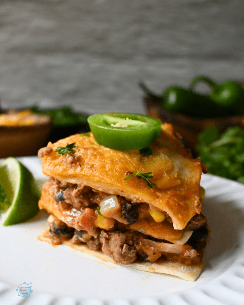 a slice of tortilla lasagna on a round white plate