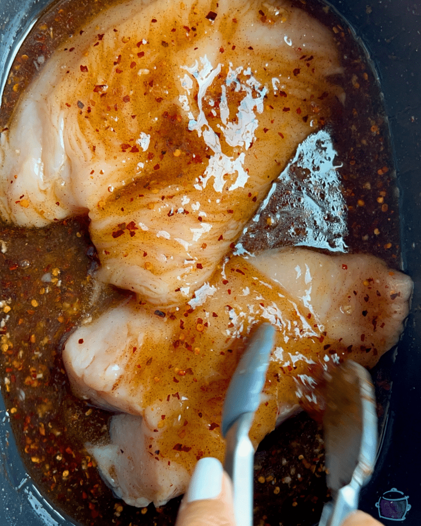 raw turkey tenderloins in slow cooker in hot honey sauce before cooking