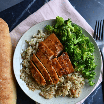 Hot honey glazed slow cooker turkey tenderloin sliced on a bed of rice with broccoli