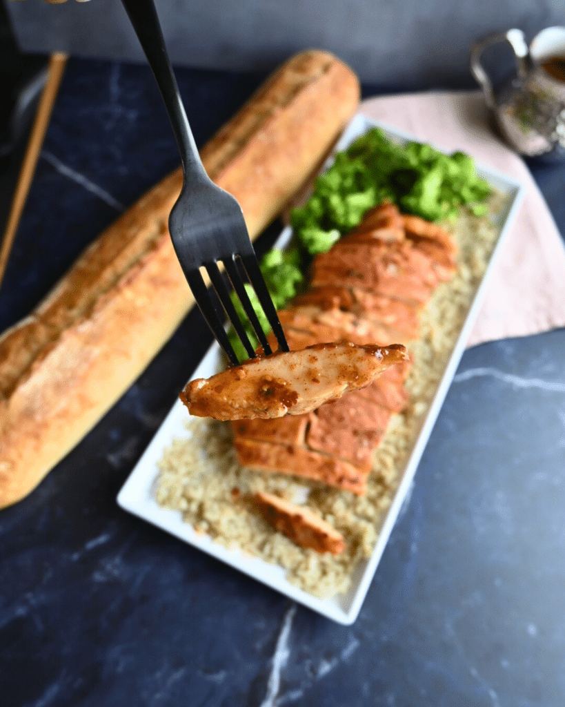 Hot honey glazed slow cooker turkey tenderloin sliced on a bed of rice