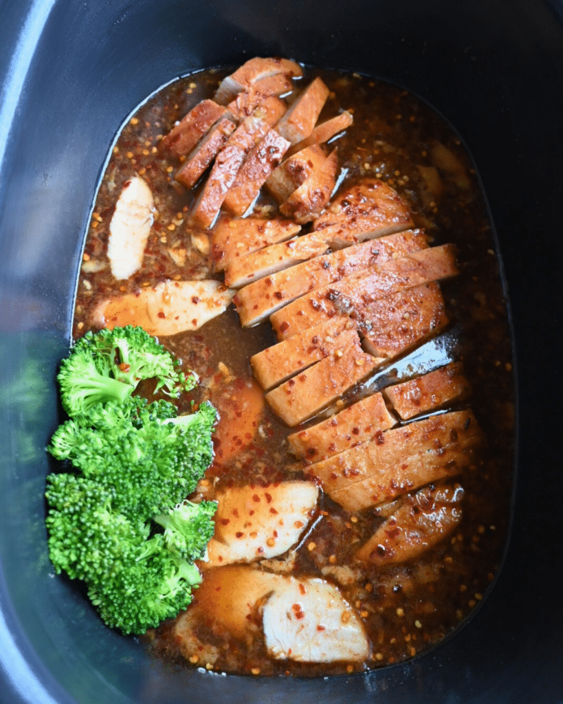 cooked hot honey turkey tenderloin that was sliced and placed back into sauce in slow cooker with a side of broccoli