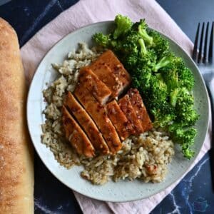 Hot honey glazed slow cooker turkey tenderloin sliced on a bed of rice with broccoli