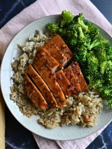 Hot honey glazed slow cooker turkey tenderloin sliced on a bed of rice with broccoli