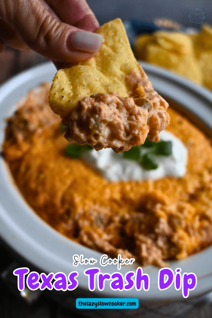 Texas trash dip being scooped up out of a slow cooker onto a tortilla chip