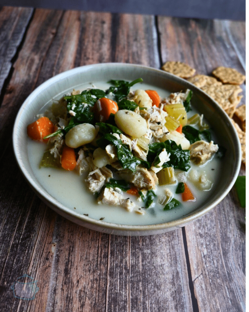 slow cooker chicken gnocchi soup in a round gray bowl