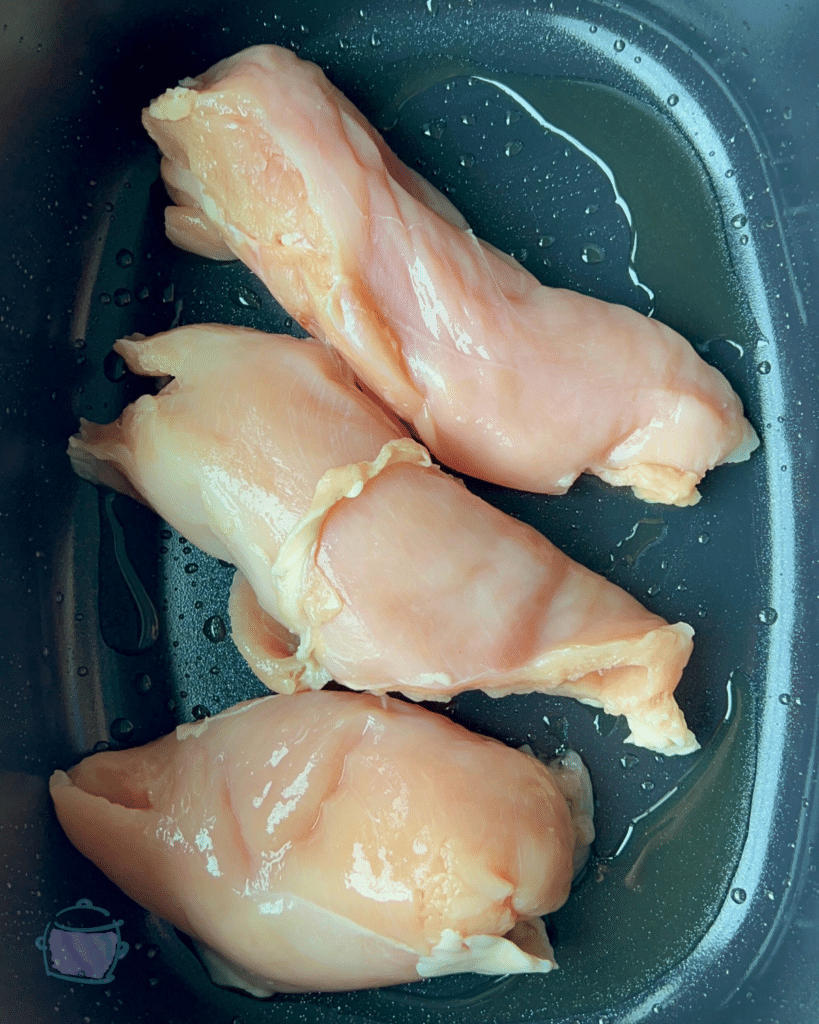 3 chicken breasts in the bottom of a greased slow cooker 