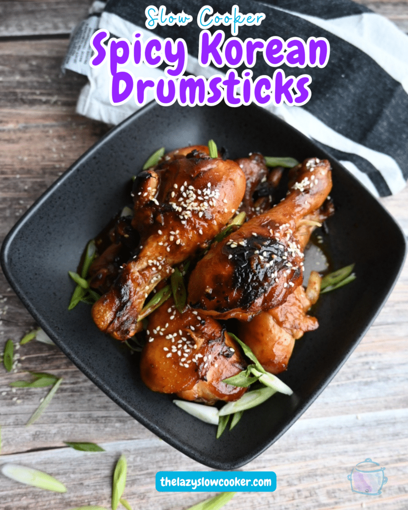 Cooked and crisped drumsticks in a black square bowl.