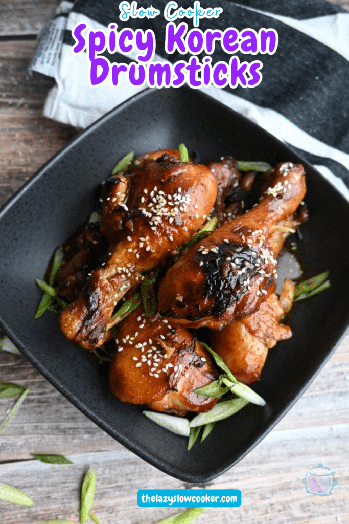 Cooked and crisped drumsticks in a black square bowl.