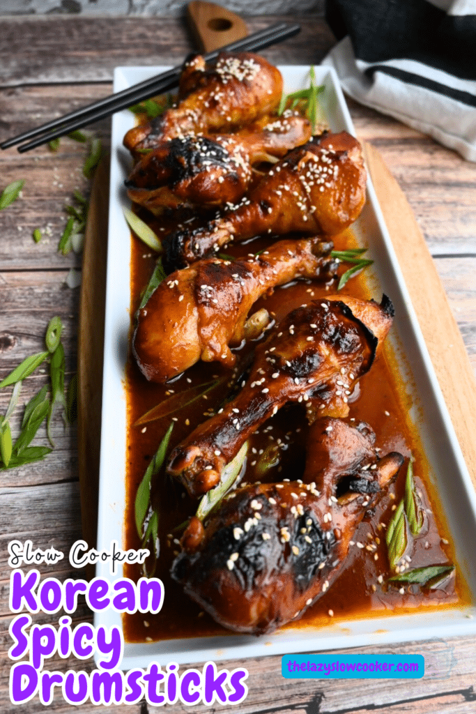 a white rectangular tray with a row of Korean spicy drumsticks