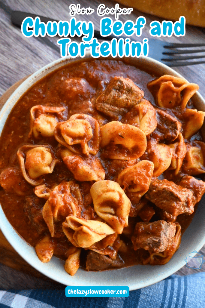 Slow Cooker Beef and Tortellini with red sauce in a round grey bowl.