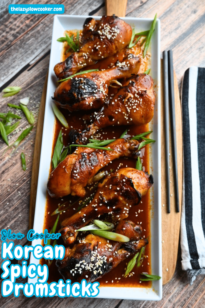 a white rectangular tray with a row of Korean spicy drumsticks