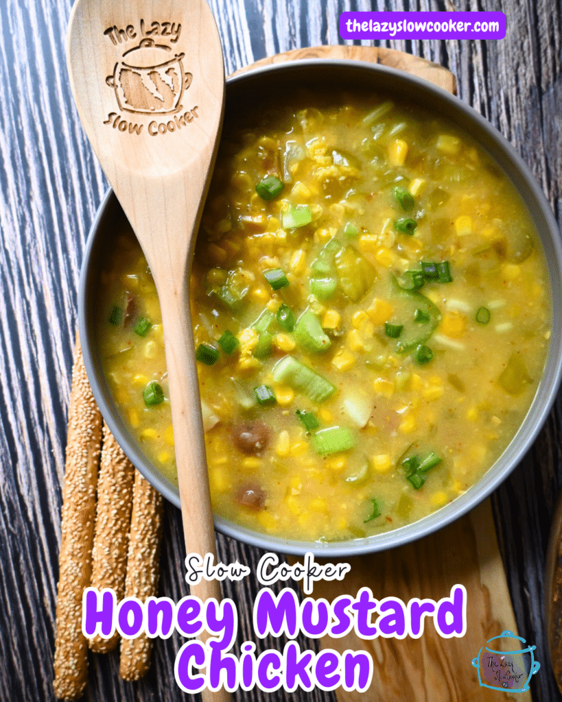 pepper and corn chowder in a round gray bowl with a wooden spoon.
