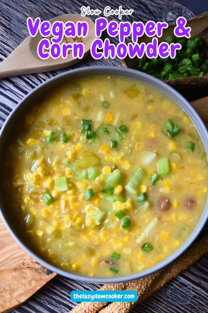 pepper and corn chowder in a round gray bowl with a wooden spoon.