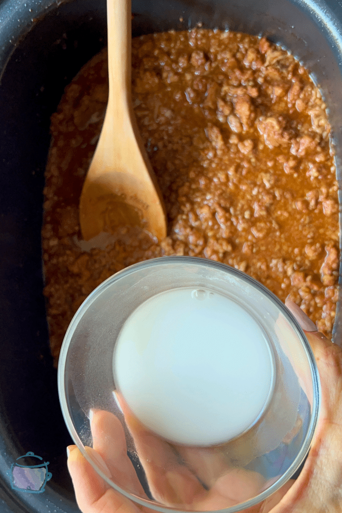 adding slurry to slow cooker sloppy joes