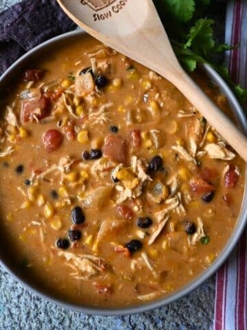 slow cooker creamy southwest chicken soup in a round gray bowl.