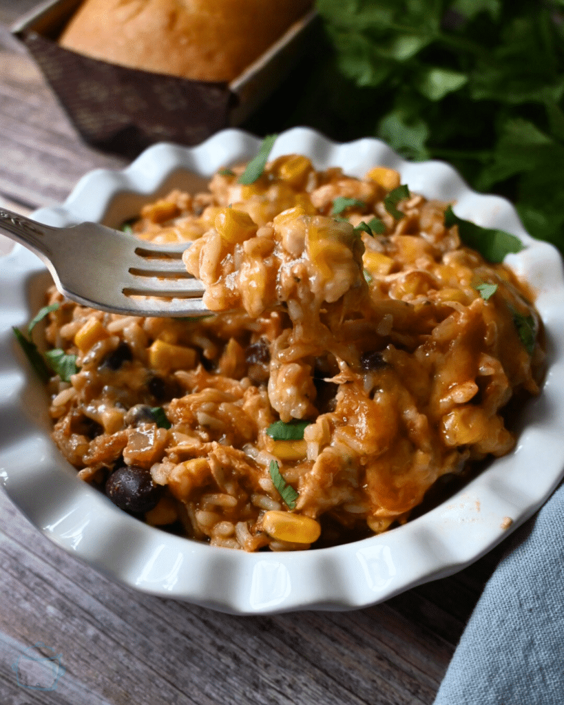 slow cooker southwest chicken in a round white bowl with a fork
