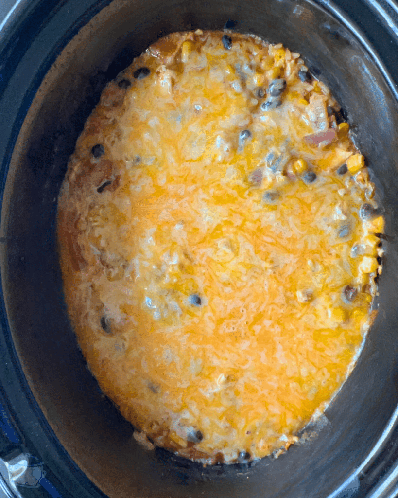 a slow cooker fill of southwest chicken casserole with melted cheese on top
