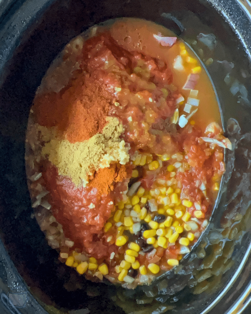 southwest chicken casserole ingredients in a slow cooker before cooking