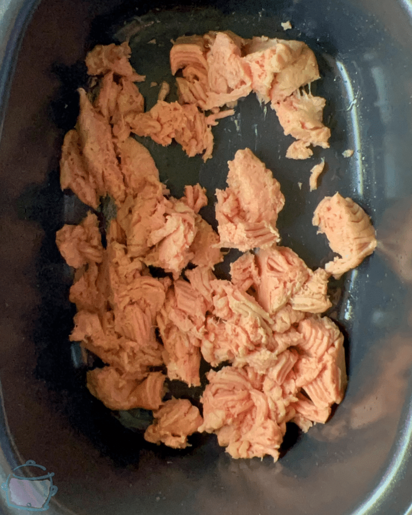 ground meat in a slow cooker slightly broken apart