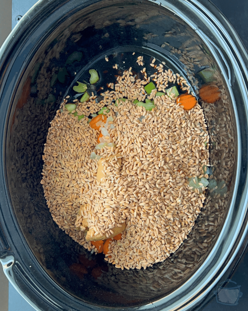 farro and veggies in a greased slow cooker
