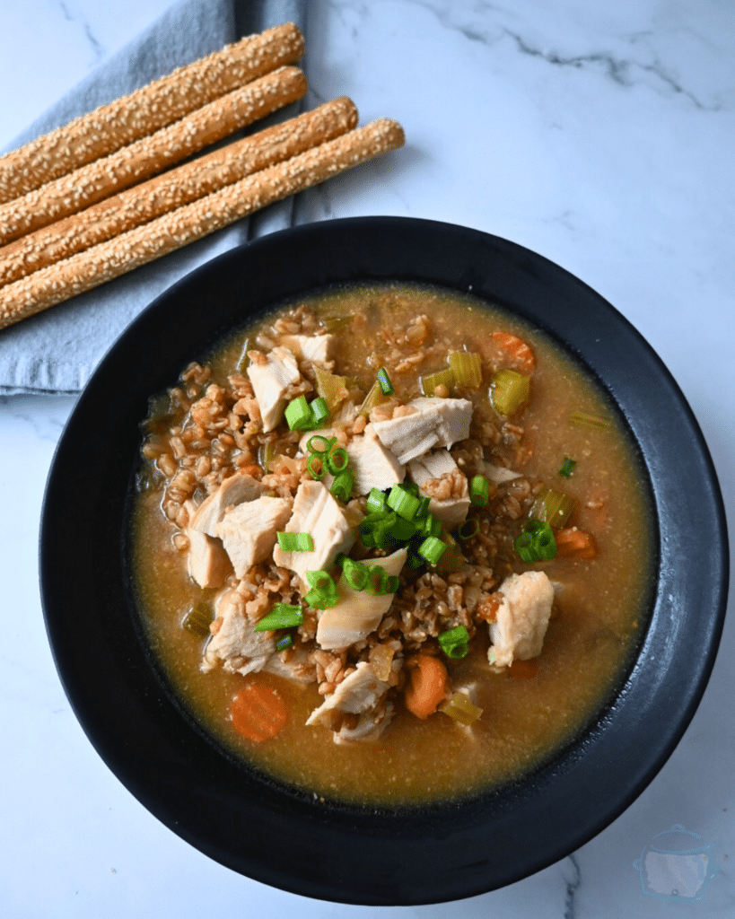 a black bowl filled with turkey farro miso soup