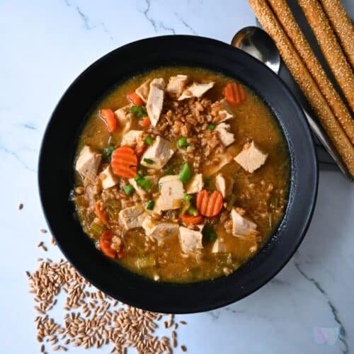 a black bowl filled with turkey farro miso soup