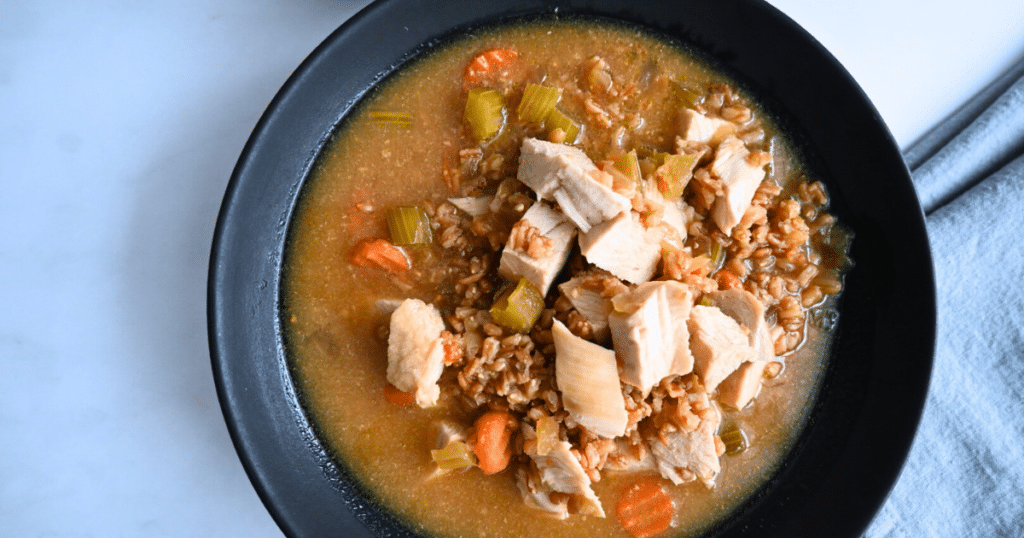 a black bowl filled with turkey farro miso soup