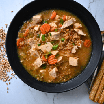 a black bowl filled with turkey farro miso soup