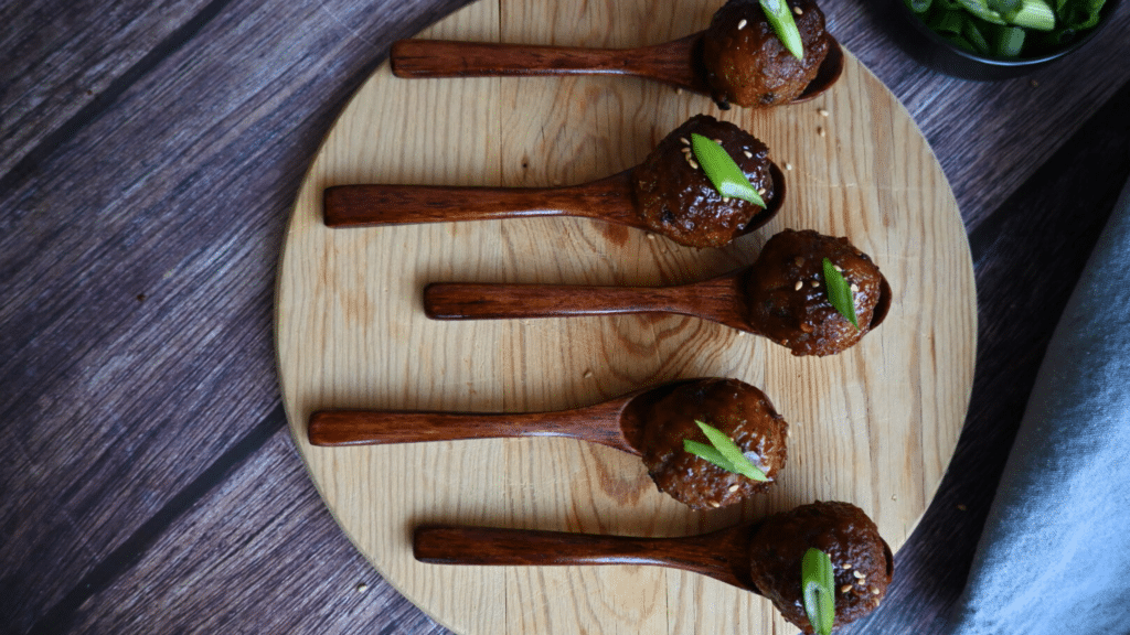 spicy maple meatballs on wooden appetizer spoons