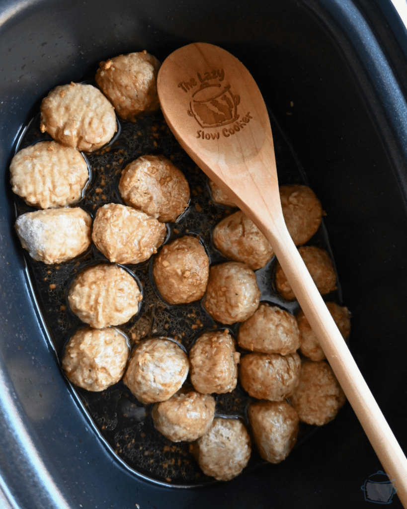 meatballs in slow cooker with sauce prior to slow cooking
