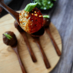 spicy maple meatballs on wooden appetizer spoon